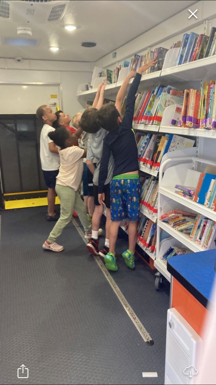 Children at library browsing books