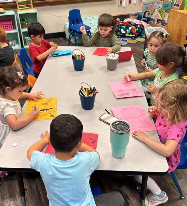 Students at table drawing