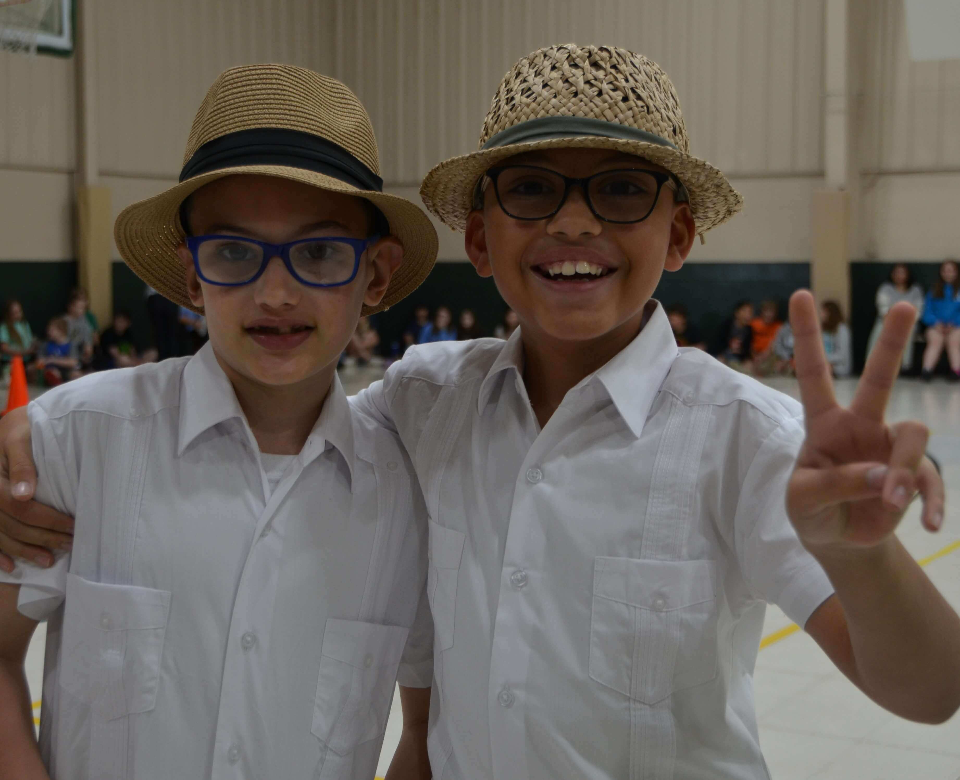 Two Smiling Students in Hats